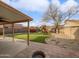 Well-maintained backyard featuring lush turf, playground, rock area, firepit and covered patio, perfect for outdoor entertaining at 3732 E South Fork Dr, Phoenix, AZ 85044