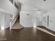 Open-concept living room with tile floors, high ceilings, and staircase access at 3732 E South Fork Dr, Phoenix, AZ 85044