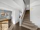Staircase with a view to the living room and a kitchen counter with stone siding at 3732 E South Fork Dr, Phoenix, AZ 85044