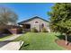 A well-maintained backyard features a hot tub, artificial grass, and mature trees creating a serene outdoor space at 38075 N Bonnie Ln --, San Tan Valley, AZ 85140