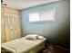 Cozy bedroom featuring a comfortable bed, window with blinds, and closet with doors at 4065 E University Dr # 271, Mesa, AZ 85205
