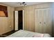 Carpeted bedroom with view of closet and window with blinds at 4065 E University Dr # 271, Mesa, AZ 85205
