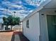 Exterior view of home with brick paver walkway and green tree at 4065 E University Dr # 271, Mesa, AZ 85205