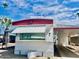Exterior view of home with awning and palm trees under blue sky at 4065 E University Dr # 271, Mesa, AZ 85205