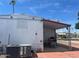 Rear exterior view of home with covered patio, table and chairs, and AC unit at 4065 E University Dr # 271, Mesa, AZ 85205