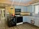 Efficient kitchen with blue cabinets, a microwave, and a washer/dryer at 4065 E University Dr # 271, Mesa, AZ 85205