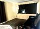 Comfortable living room with hardwood floors, dark curtains, and modern seating at 4065 E University Dr # 271, Mesa, AZ 85205