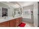 Bright bathroom with a double sink vanity, large mirror, bathtub, and tile floors at 4830 S Grenoble --, Mesa, AZ 85212