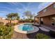 Backyard with a sparkling pool, patio area, and lush desert landscaping at 5110 W Sweet Iron Pass, Phoenix, AZ 85083