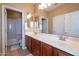 Bathroom with dual sinks, wood cabinets, and separate toilet and shower area at 5110 W Sweet Iron Pass, Phoenix, AZ 85083