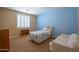 Charming bedroom with a comfortable bed, blue accent wall, and plantation shutters at 5110 W Sweet Iron Pass, Phoenix, AZ 85083