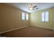 Bright bedroom featuring plantation shutters, a ceiling fan, and neutral wall colors at 5110 W Sweet Iron Pass, Phoenix, AZ 85083