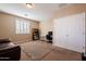 Inviting bedroom featuring neutral tones, plush carpet, and ample natural light from the window with plantation shutters at 5110 W Sweet Iron Pass, Phoenix, AZ 85083