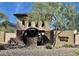 Stetson Valley entrance showcasing unique architectural design elements and stone accents in a desert landscape at 5110 W Sweet Iron Pass, Phoenix, AZ 85083