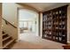 Spacious entryway with staircase, featuring a built-in bookcase and view into the living room at 5110 W Sweet Iron Pass, Phoenix, AZ 85083