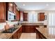 A well-equipped kitchen features granite countertops, stainless steel appliances, and wooden cabinetry at 5110 W Sweet Iron Pass, Phoenix, AZ 85083