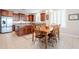 Bright eat-in kitchen features wood dining set, ample natural light, and kitchen island with granite countertop at 5110 W Sweet Iron Pass, Phoenix, AZ 85083
