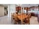 Eat-in kitchen has wood dining table, six chairs, and view to main kitchen with stainless steel appliances at 5110 W Sweet Iron Pass, Phoenix, AZ 85083