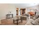 Well-lit living room with plush sofas, a glass coffee table, neutral carpet and a piano at 5110 W Sweet Iron Pass, Phoenix, AZ 85083