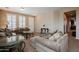 Comfortable living room with plush sofas, a glass coffee table, neutral carpet and shuttered windows at 5110 W Sweet Iron Pass, Phoenix, AZ 85083