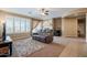The living room offers a ceiling fan, a fireplace, large windows and carpeted floors at 5110 W Sweet Iron Pass, Phoenix, AZ 85083