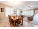 Open living space features dining table, ceiling fan, and an inviting living room with plush seating at 5110 W Sweet Iron Pass, Phoenix, AZ 85083