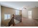 Spacious upstairs loft featuring neutral tones, plush carpet, and a decorative railing at 5110 W Sweet Iron Pass, Phoenix, AZ 85083