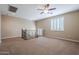 Spacious upstairs loft featuring neutral tones, plush carpet, and ample natural light from the windows with plantation shutters at 5110 W Sweet Iron Pass, Phoenix, AZ 85083