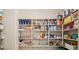 Walk-in pantry features adjustable shelving to maximize storage in this well-organized kitchen at 5110 W Sweet Iron Pass, Phoenix, AZ 85083
