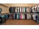 Large walk-in closet offering substantial storage with organized shelving and hanging rods for clothing and accessories at 5110 W Sweet Iron Pass, Phoenix, AZ 85083