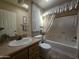 Bathroom with vanity, toilet and shower/tub combination with curtains at 650 N Hawes Rd # 4834, Mesa, AZ 85207