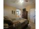 Cozy bedroom featuring a comfortable bed, ceiling fan, TV, and arched doorway to the bathroom at 650 N Hawes Rd # 4834, Mesa, AZ 85207