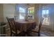 The dining area features a cozy round table and chairs, bathed in natural light from a nearby window and door at 650 N Hawes Rd # 4834, Mesa, AZ 85207
