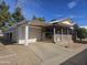 Charming single-story home featuring a covered porch, carport, and low maintenance landscaping at 650 N Hawes Rd # 4834, Mesa, AZ 85207