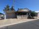 Charming single-story home with a covered porch, attached garage, and manicured landscaping at 650 N Hawes Rd # 4834, Mesa, AZ 85207