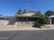Charming single-story home with a covered porch, attached garage, and manicured landscaping at 650 N Hawes Rd # 4834, Mesa, AZ 85207