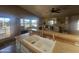 The kitchen features light countertops and cabinets, with an open view into the living room and out to the patio at 650 N Hawes Rd # 4834, Mesa, AZ 85207