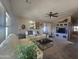 Bright living room with vaulted ceilings, ceiling fan, a large window with sunlight, and a neutral color palette at 650 N Hawes Rd # 4834, Mesa, AZ 85207