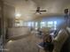A sunlit living room showcases a vaulted ceiling with skylight and a seamless transition to an open-concept kitchen at 650 N Hawes Rd # 4834, Mesa, AZ 85207
