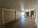 A covered outdoor patio features durable epoxy flooring and access to both a garage and the interior of the home at 650 N Hawes Rd # 4834, Mesa, AZ 85207