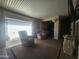 This covered outdoor patio is set up for comfort with two chairs and a table, adjacent to garage and home access at 650 N Hawes Rd # 4834, Mesa, AZ 85207