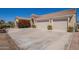 Attached two-car garage featuring a large driveway and desert landscaping at 6935 N Valley Rd, Eloy, AZ 85131