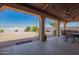 Covered patio with ceiling fans, decorative string lights, and a view of the expansive backyard at 6935 N Valley Rd, Eloy, AZ 85131