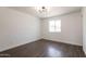 Bedroom with dark wood floors, white walls, and natural lighting at 743 E Holmes Ave, Mesa, AZ 85204