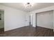 Bedroom showcasing an open closet, white walls and dark wood flooring at 743 E Holmes Ave, Mesa, AZ 85204