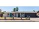 Charming single-story home featuring a well-kept yard, attached garage, and painted brick exterior at 743 E Holmes Ave, Mesa, AZ 85204