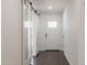 Bright hallway with wood floors and a glass sliding barn door on the left at 743 E Holmes Ave, Mesa, AZ 85204