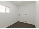 Neutral-colored laundry room with wood-look floors and utility hook-ups at 743 E Holmes Ave, Mesa, AZ 85204