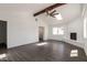 Bright living room with a vaulted ceiling, wood beam, and a painted fireplace at 743 E Holmes Ave, Mesa, AZ 85204