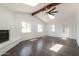 Spacious living room with a vaulted ceiling, skylights, fireplace, and ceiling fan at 743 E Holmes Ave, Mesa, AZ 85204